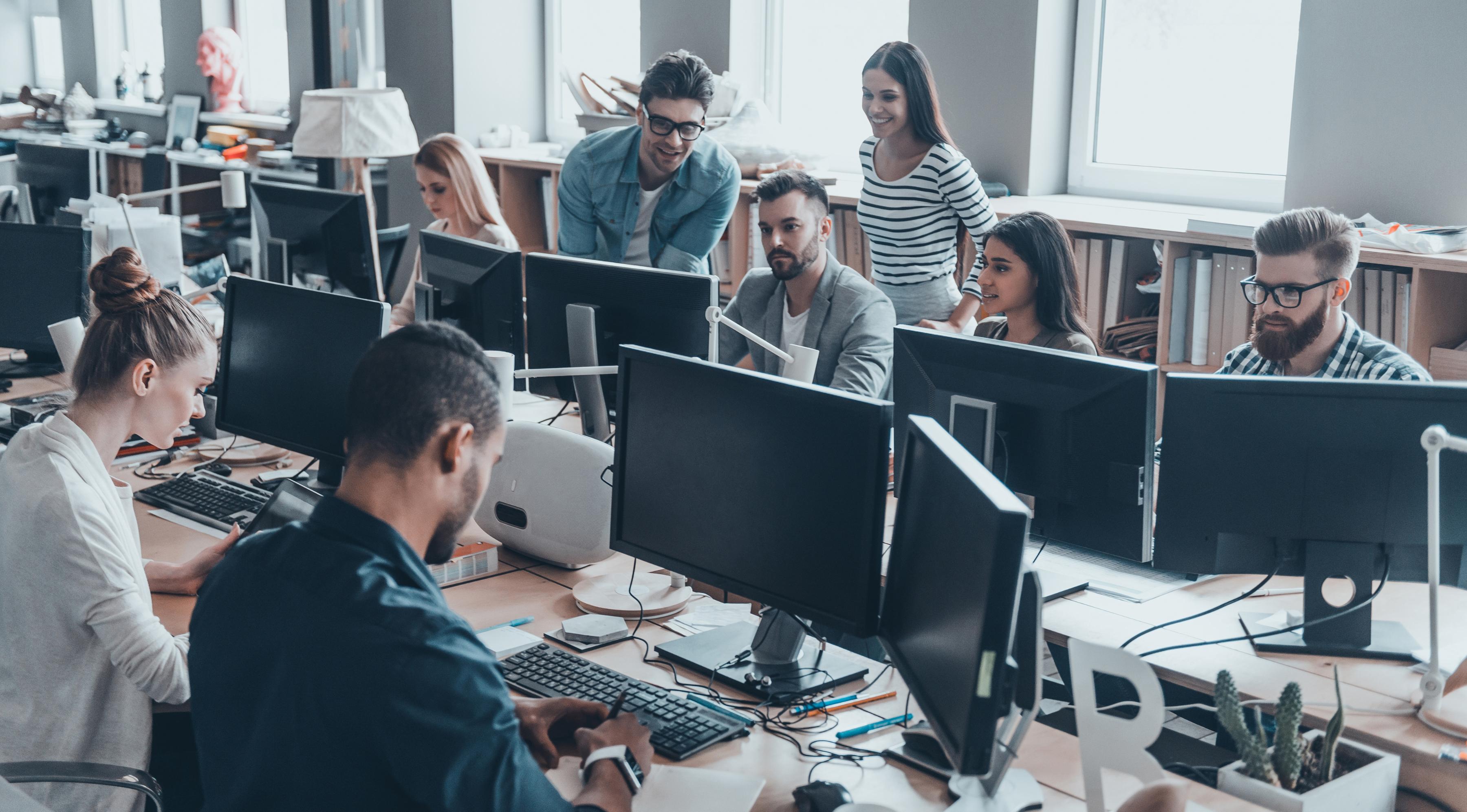 A group of young business people working in a busy modern office