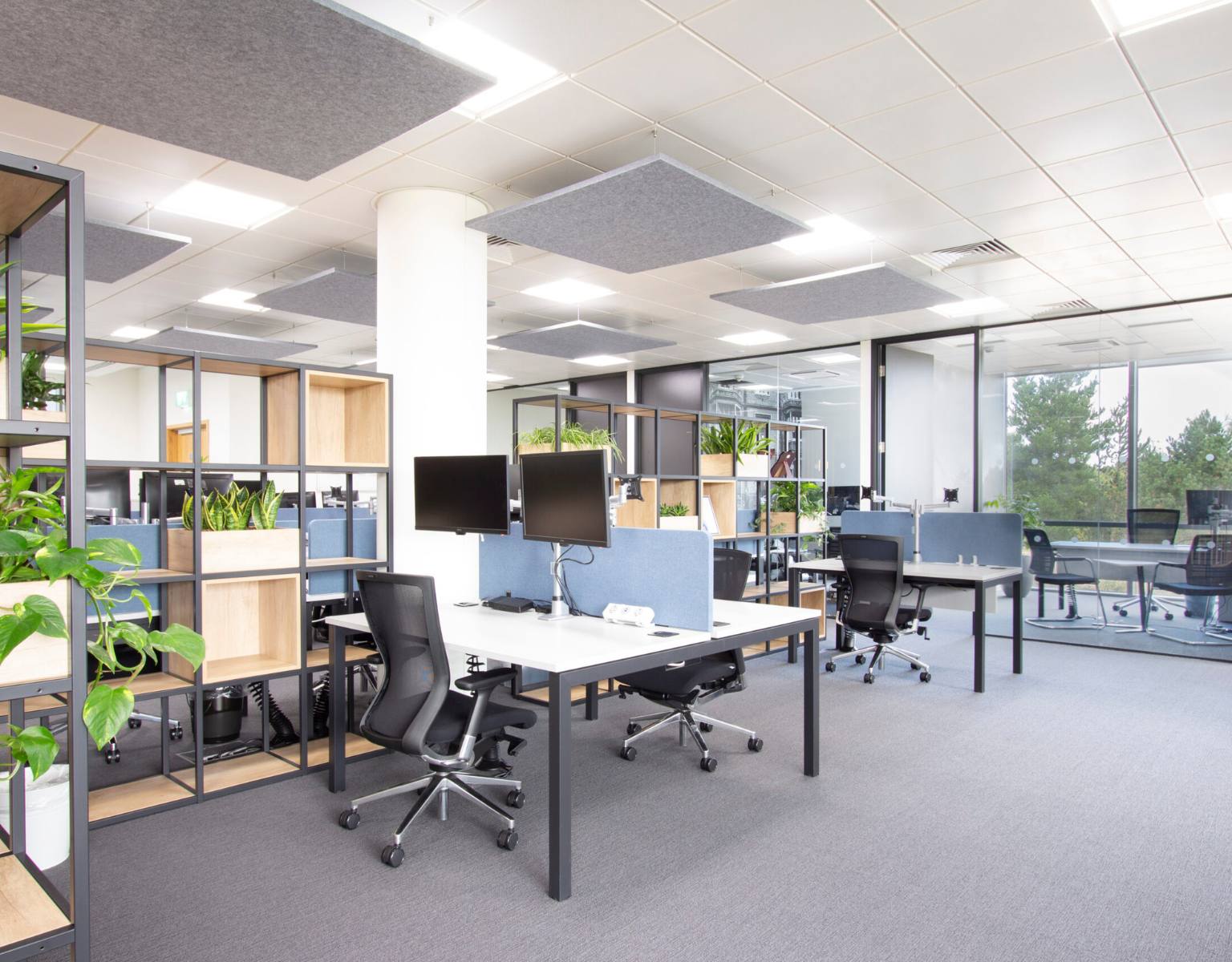 An empty modern office with desks and computers